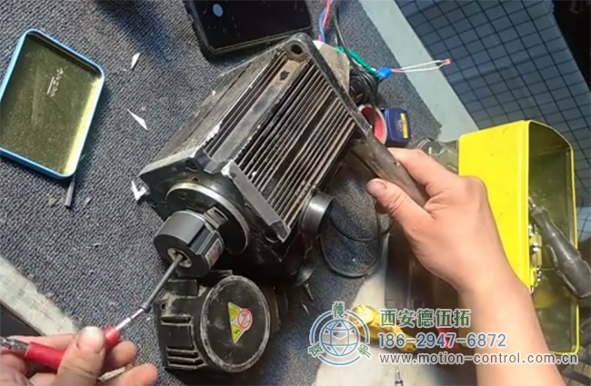 图为维修人员拆卸增量编码器的现场照片